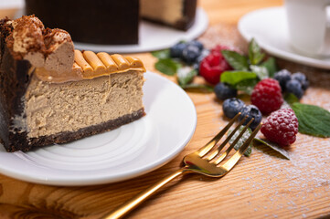 close-up of cheesecake with cream filling, decorated with fresh berries, blueberries and raspberries, festive New Year's cake, Christmas. From above