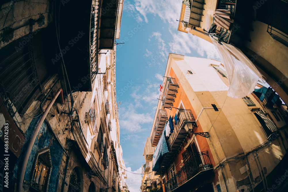 Wall mural street view in palermo. traditional old houses against blue sunny sky.