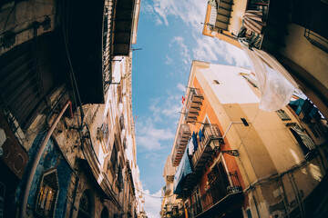 Street view in Palermo. Traditional old houses against blue sunny sky. - obrazy, fototapety, plakaty