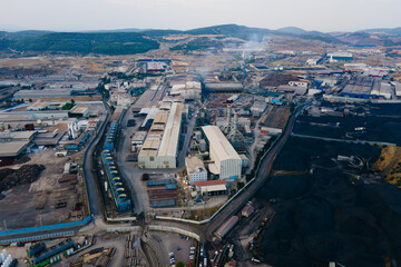 Aerial shot of Industry park with power plant and coal bulk storage terminal with coal heaps