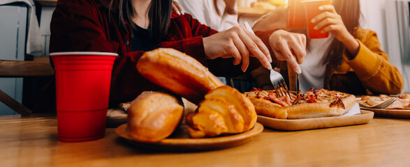 .Friends hangout. Young female celebrating birthday party at weekend at home, eating pizza, drinking champagne, party, lifestyle, friendship