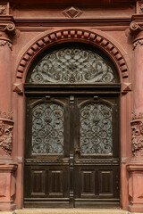 Old wooden door with decorative elements in city
