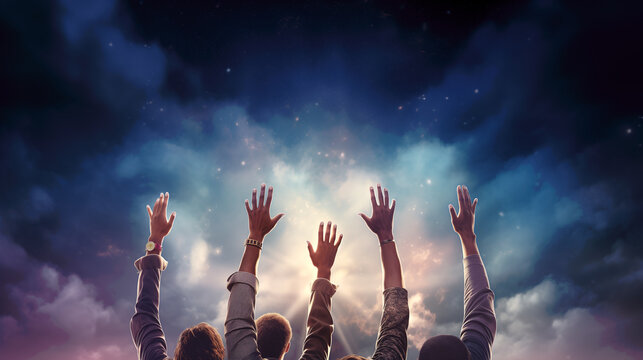 People raising their arm to the sky, to pray, cheer, great, or show solidarity. Group of happy people on dark sky background with sunlight and clouds, waving, cheering, and welcoming. Copy space.