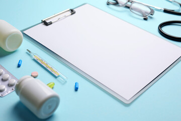 Doctor's desk top view. Set of different doctor accessories on a colored background. Pills,...
