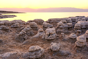 Fototapeta na wymiar Dead Sea coast with stones covered by salt