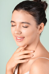 Young woman with beautiful lips on green background, closeup