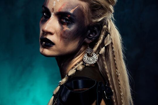 Photo of viking tribal leader queen with black face art prepare for legend ancient battle over dark mist background