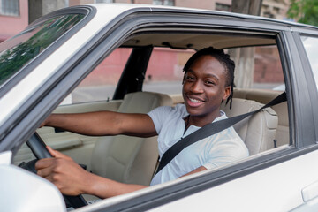 young happy male driver  riding a car, cheerful person