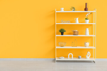 Modern shelf unit near orange wall