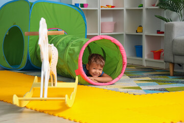 Cute little boy playing in kindergarten