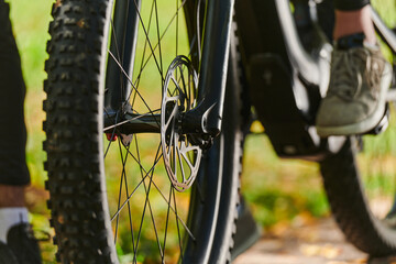 A sports bicycle races through the park, its components in focused motion spinning wheels, agile...