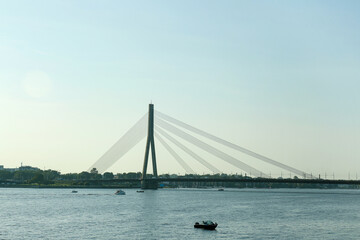 View of beautiful river with modern bridge in European city on sunny day