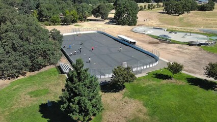Teams playing street hockey on a court. 