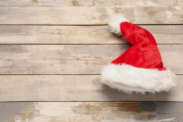 Obraz na płótnie Canvas Santa Claus hat on light wooden background