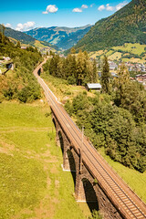 Alpine summer view with a stone railway bridge at Bad Hofgastein, St. Johann im Pongau, Salzburg,...