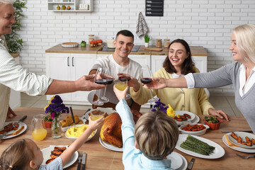 Happy family having dinner at festive table on Thanksgiving Day