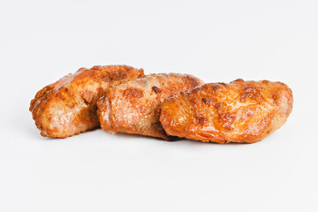 Chicken wings fried until half cooked, semi-finished product with fresh herbs on a white background. Fast food. Fast cooking.Quick cooking at home. Copy space.Fast homemade food.Raw chicken meat.