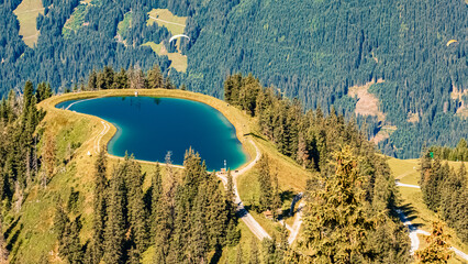 Alpine summer view with Lake Spiegelsee and a paraglider at Mount Fulseck, Dorfgastein, St. Johann...