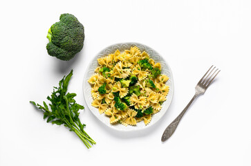 Plate of tasty pasta with broccoli on white background