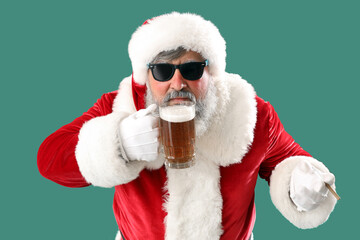 Bad Santa Claus drinking beer on green background