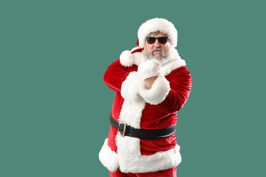 Bad Santa Claus showing vulgar gesture on green background