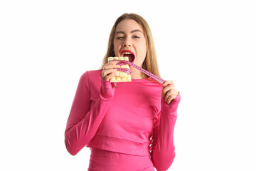 Young woman with white chocolate bar and tape measure on light background