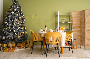 Interior of festive room with Christmas tree, decorations and beautiful table serving