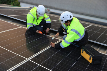 Two engineers installed solar cell farm power plant eco-technology on the roof.  Renewable and Sustainable energy