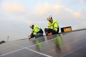 Two engineers installed solar cell farm power plant eco-technology on the roof.  Renewable and Sustainable energy