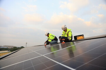 Two engineers installed solar cell farm power plant eco-technology on the roof.  Renewable and Sustainable energy