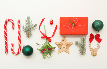 Mistletoe branch with Christmas decorations on white background