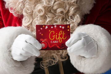 Santa Claus with gift card, closeup
