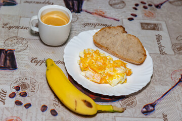 Healthy breakfast, eggs, naturally fermented bread, banana and unsweetened coffee