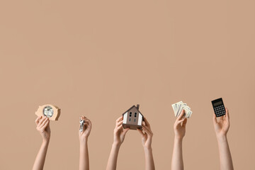 Female hands with house figure, keys, money and calculator on color background. Concept of buying real estate - obrazy, fototapety, plakaty
