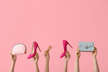 Female hands with stylish shoes and accessories on pink background - obrazy, fototapety, plakaty