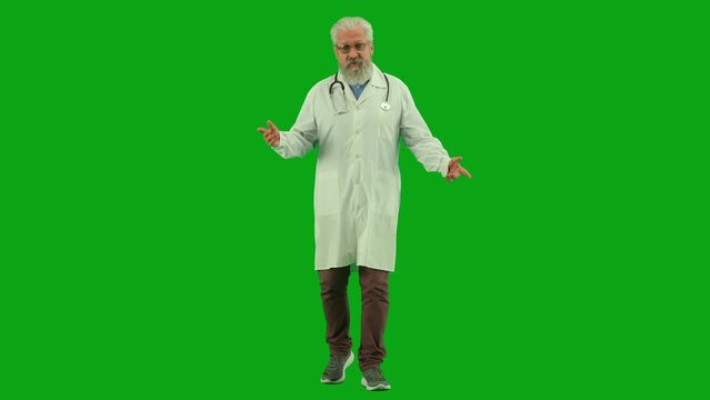 Portrait of aged man medic on chroma key green screen. Senior doctor in uniform walking and talking about health care issues and gives advices.