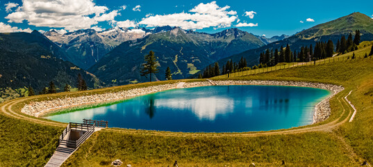 Alpine summer view with reflections in a lake at Mount Stubnerkogl, Bad Gastein, St. Johann im...