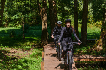 A blissful couple, adorned in professional cycling gear, enjoys a romantic bicycle ride through a park, surrounded by modern natural attractions, radiating love and happiness