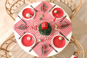 Festive Christmas dinner table setting with ornaments and fir branches, top view