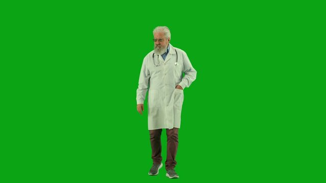 Portrait of aged man medic on chroma key green screen. Senior doctor in uniform making rounds in hospital, greeting people and saying hello.
