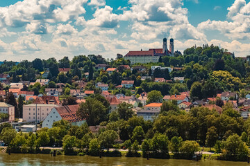 Fototapeta na wymiar Cloudy summer view with a monastery at Vilshofen, Danube, Bavaria, Germany