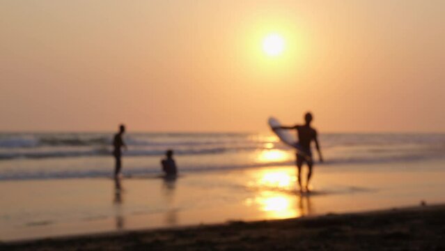 People relax carefree on seashore in rays sunset. Holidays in hot countries help forget about hustle and bustle live time carefree. Blurred frame will convey atmosphere carefree happiness of holiday