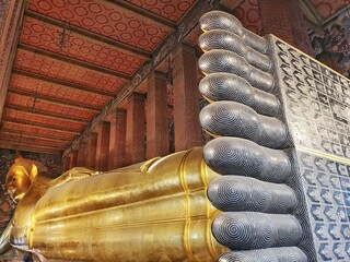 Detail of the Reclining Buddha statue in temple Wat Pho in Bangkok, Thailand
