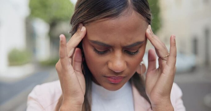 Woman, face or headache in street with pain, brain fog or stress for mental health, anxiety and burnout. Person, migraine or strain from depression, risk or problem with temple massage or fatigue