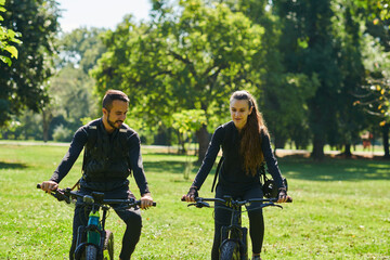 A blissful couple, adorned in professional cycling gear, enjoys a romantic bicycle ride through a...