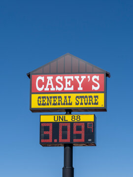 A Casey's pole sign with the blue sky background. Ogallala, NE, USA, on May 8, 2023. Casey's Retail Company is a chain of convenience stores in the Midwestern and Southern United States.