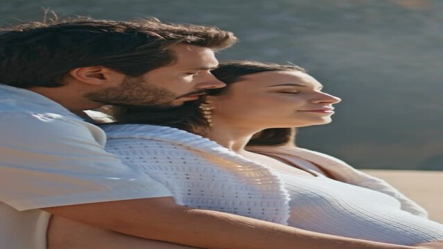 Pregnant couple looking sea standing sand beach summer holiday vertical closeup