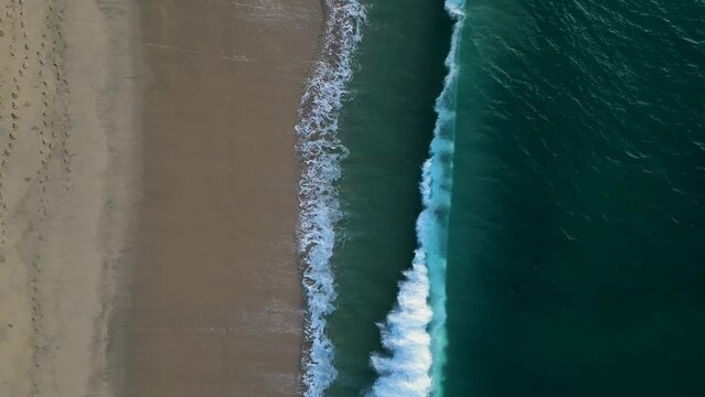 Top down drift along crashing shoreline waves