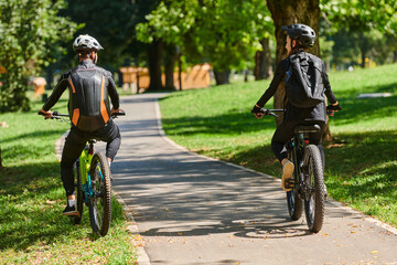 Naklejka premium A blissful couple, adorned in professional cycling gear, enjoys a romantic bicycle ride through a park, surrounded by modern natural attractions, radiating love and happiness