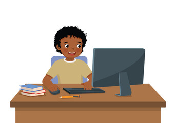 Cute little African boy student study using Computer PC at the desk